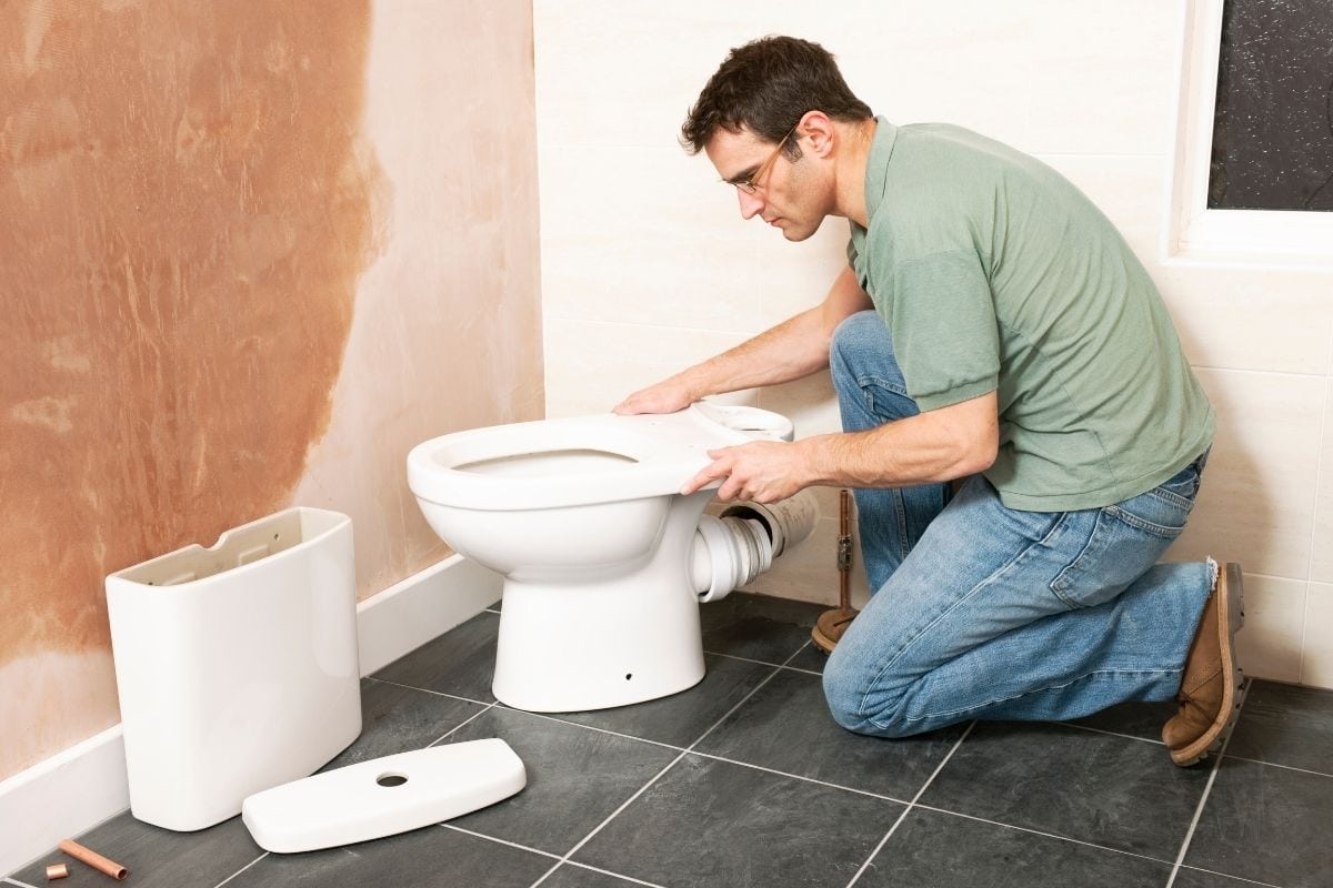 a man is installing a new toilet