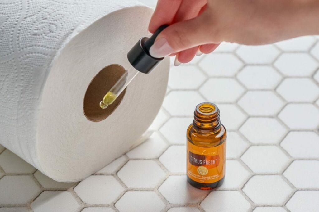 drops of citrus essential oil in toilet paper
