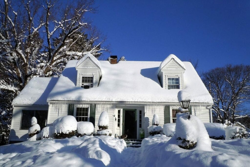 house covered with snow during winter