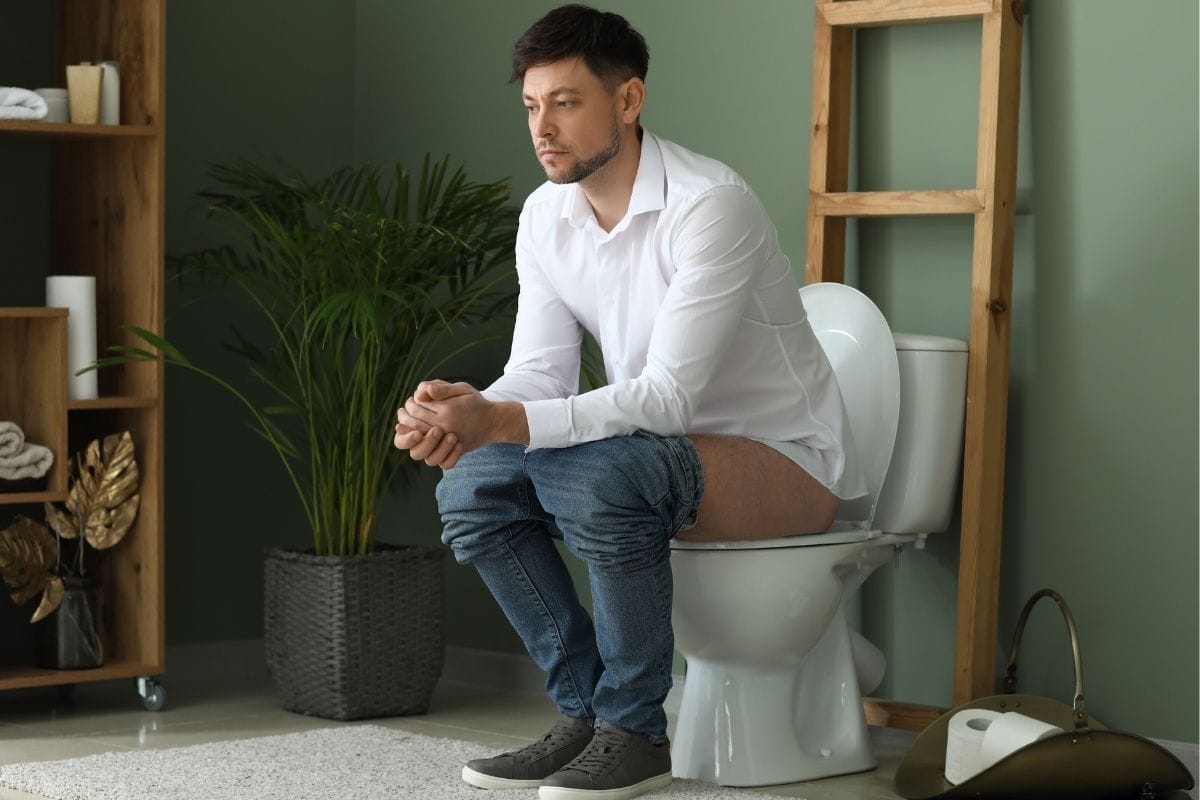 a man sitting on a toilet