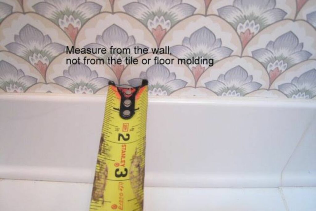 measuring toilet's rough-in distance using a measuring tape