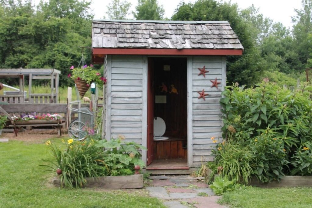an outhouse with garden outside
