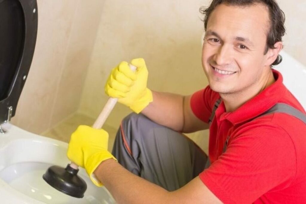 a plumber repairing clogged toilet