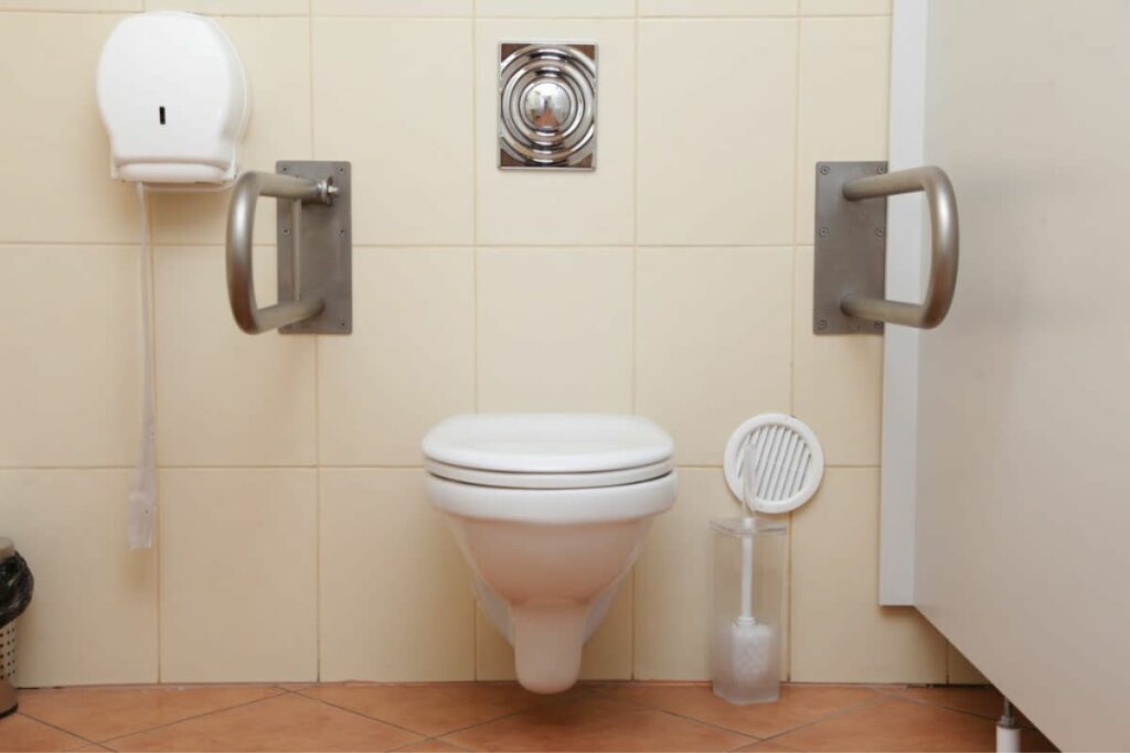 ADA wall-mounted toilet with handrails