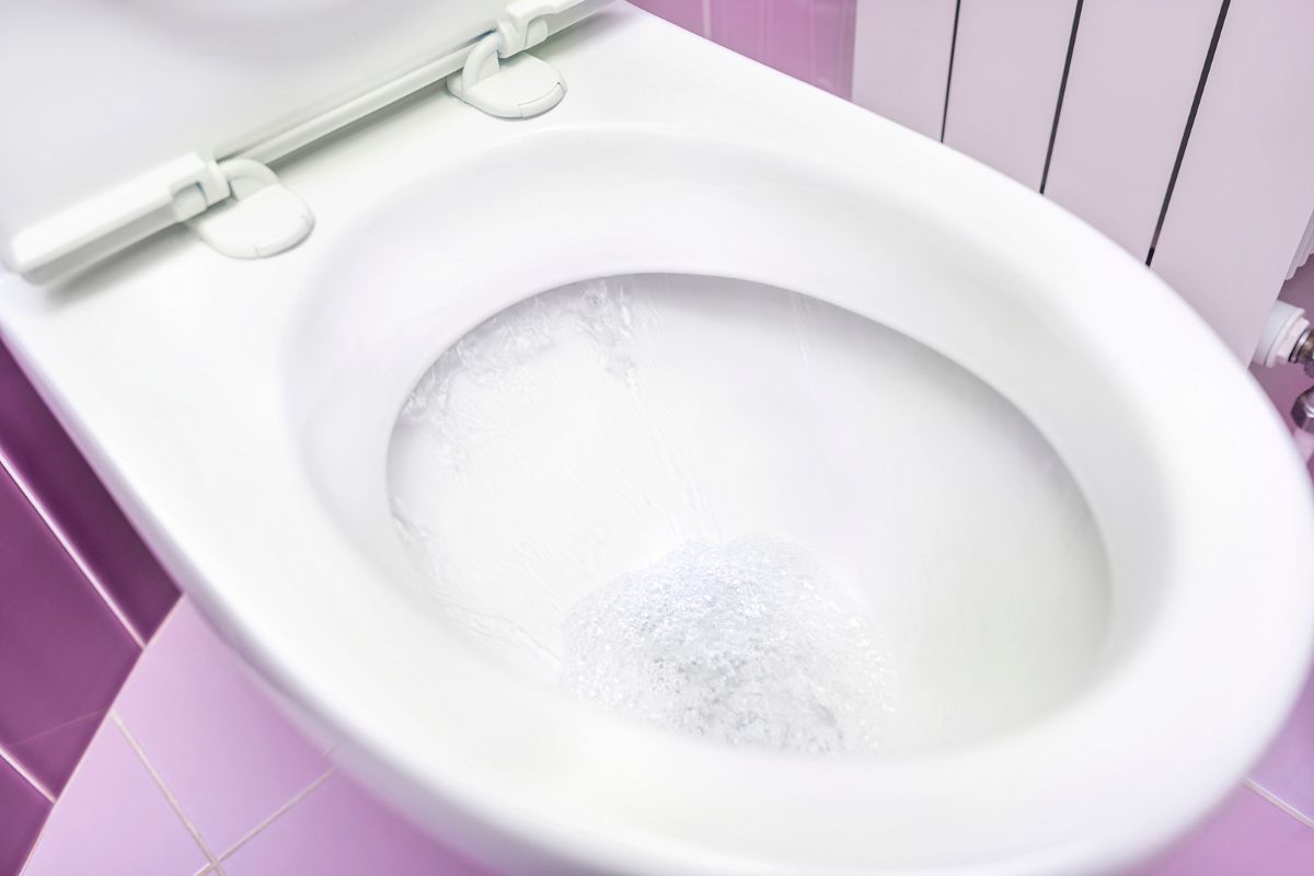 close up of toilet bowl with running water