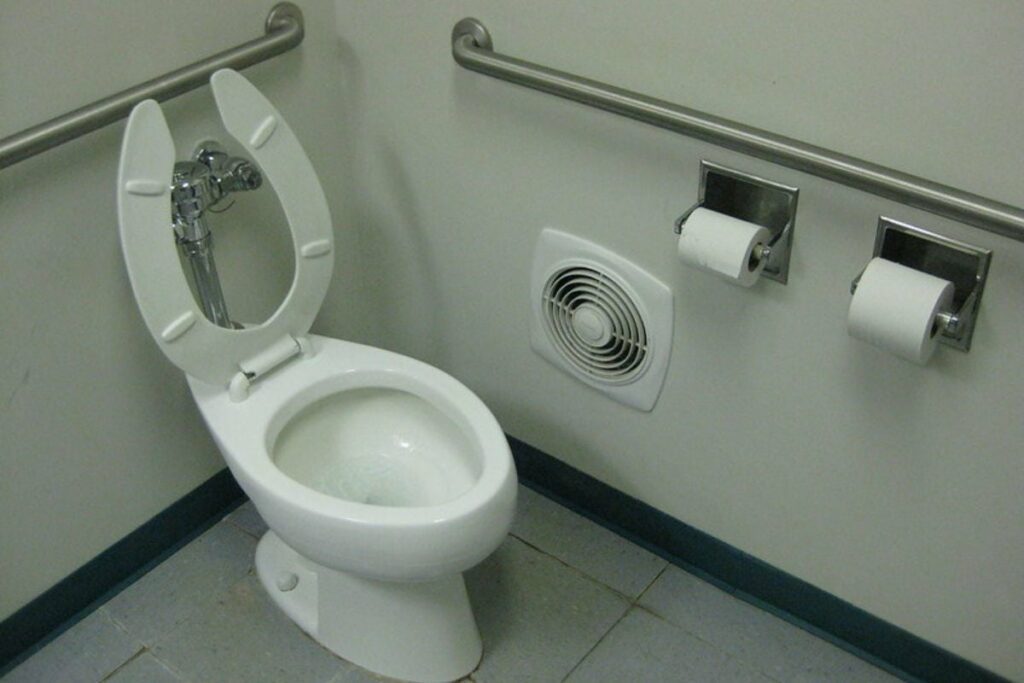 a toilet with exhaust fan as ventilation
