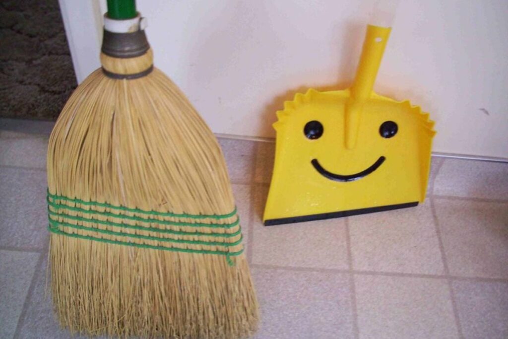 yellow dustpan and broom