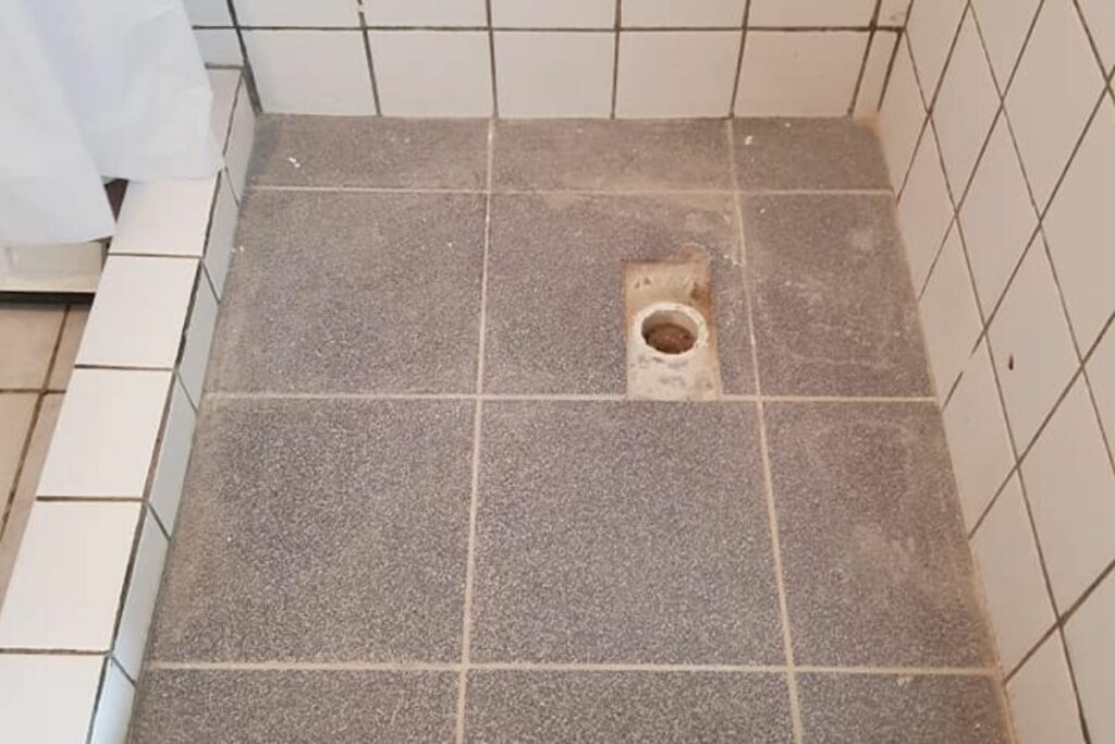 shower drain cover and grout removed