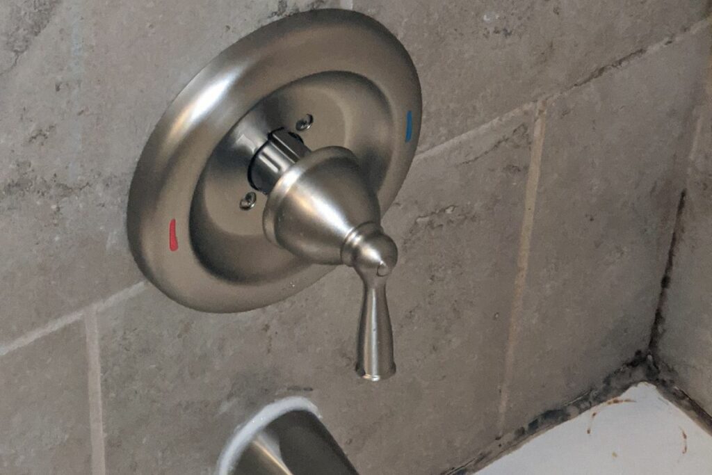 shower valve knob indicating hot and cold