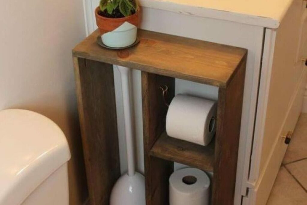 small bathroom cabinet with a toilet paper holder