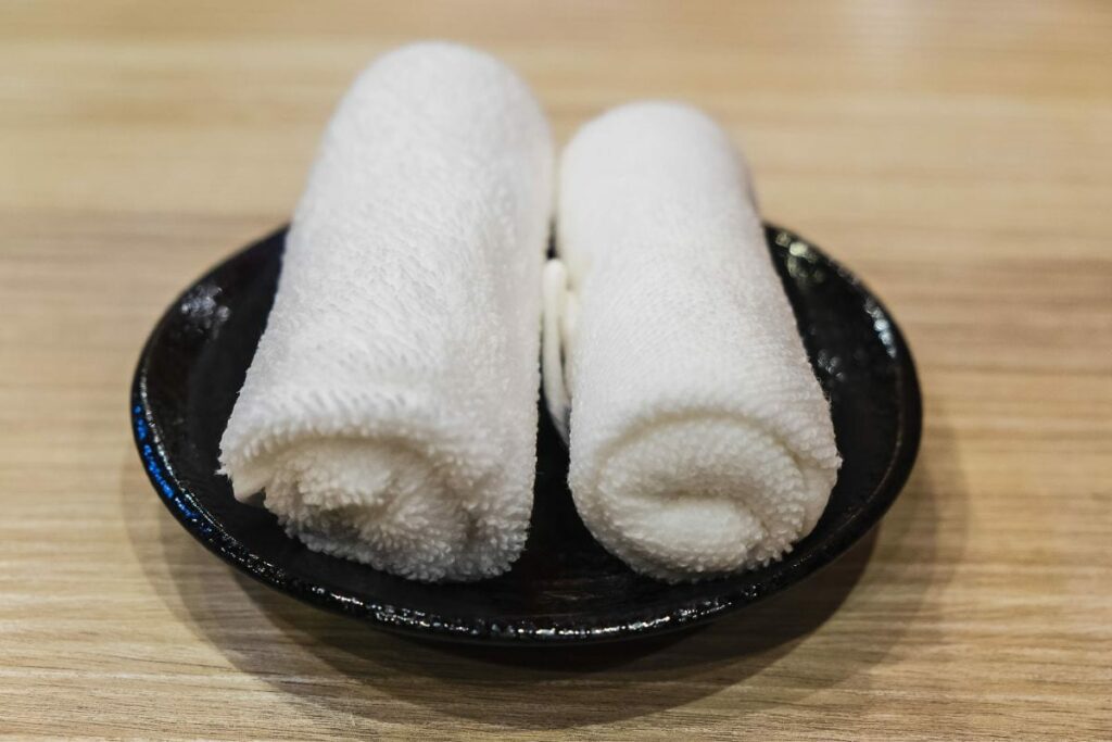 two finger tip towels on a small plate
