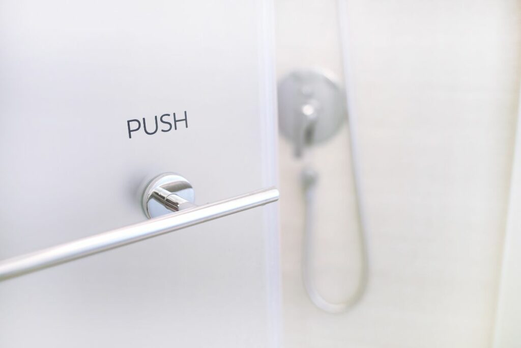 a shower door with push sign