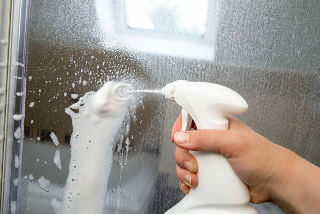spray the cleaner on dirty shower door
