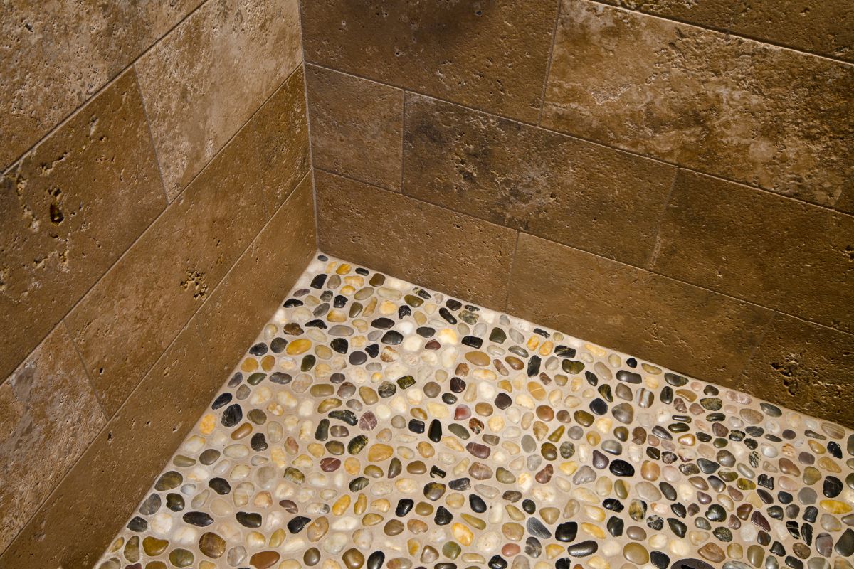 close up photo of a shower with pebble floor