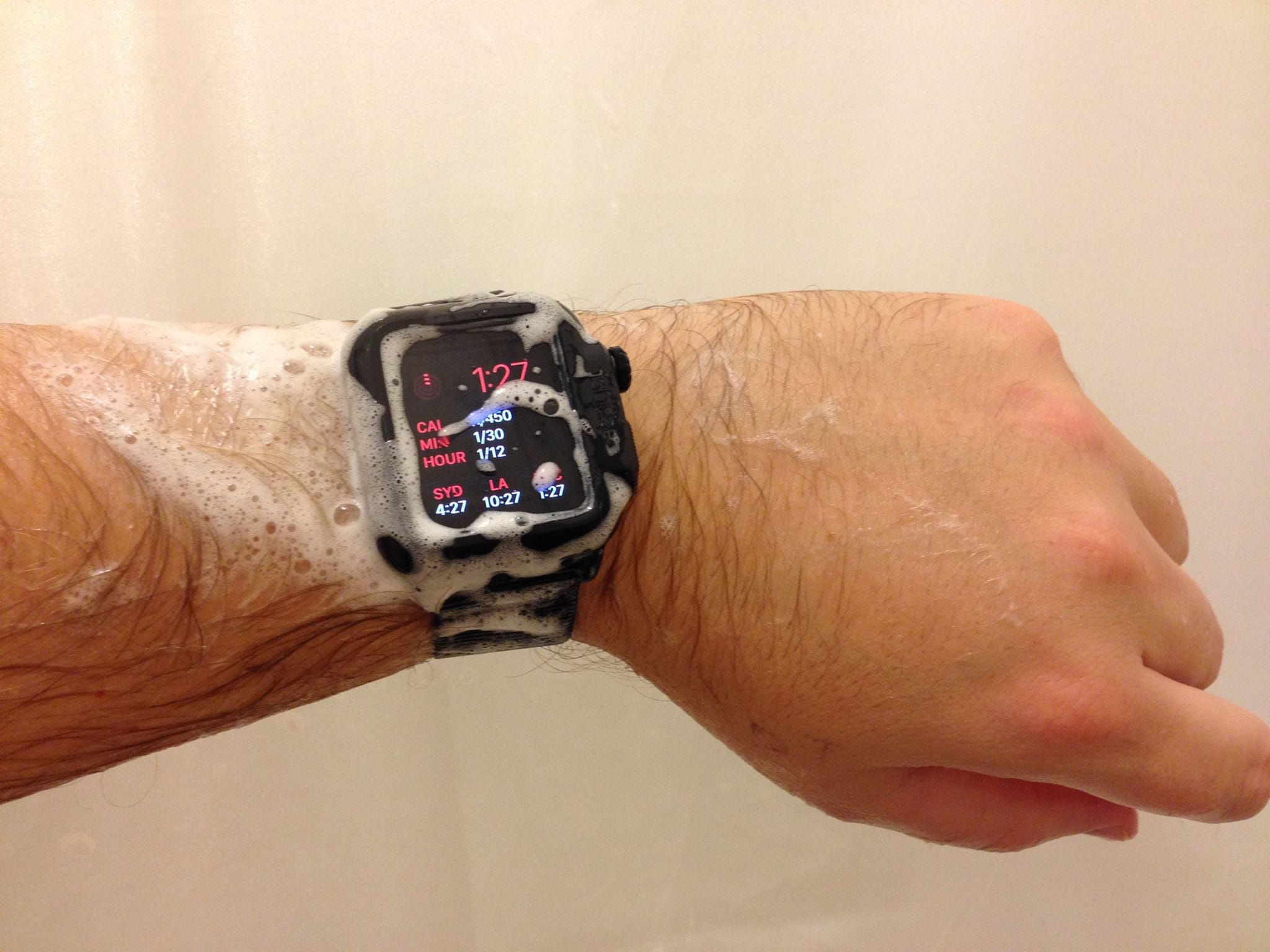 wearing black apple watch while showering and with shampoo on hand