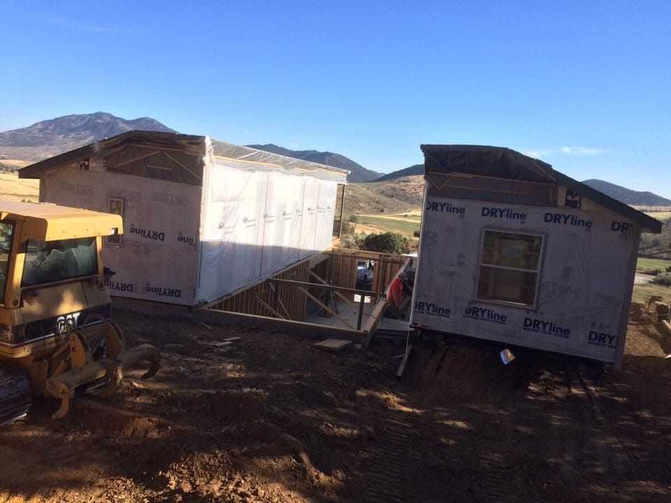 a modular home is being installed on  a basement foundation