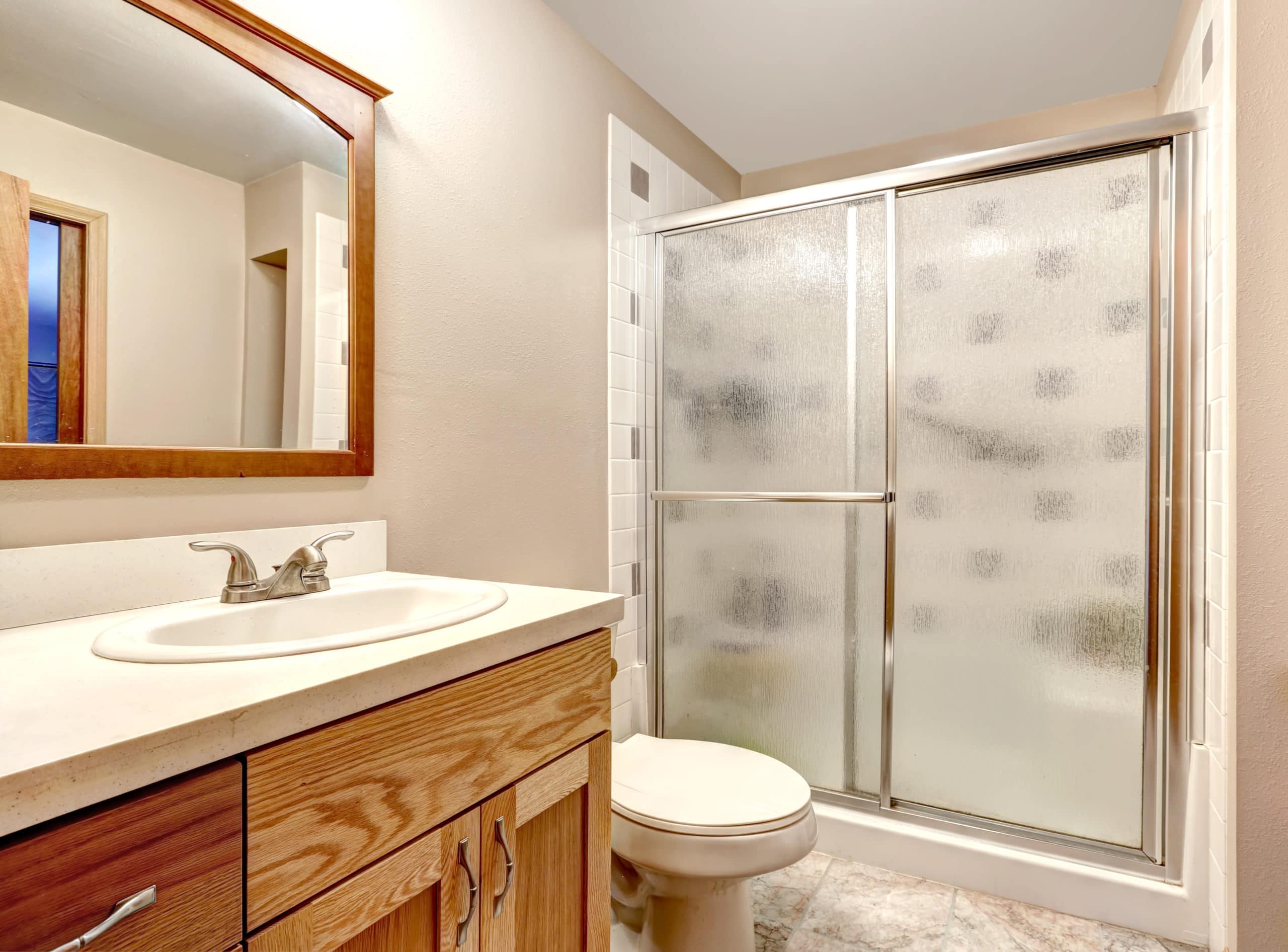 Bathroom interior with cabinet and glass door shower
