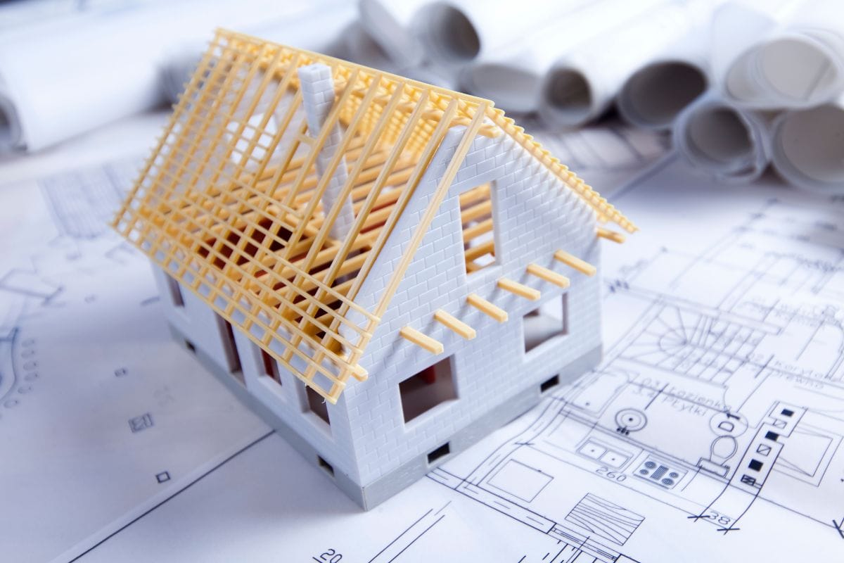 a model house on top of a house blueprint