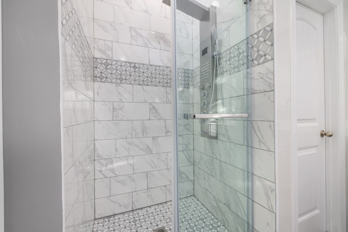a modern shower with sliding glass shower door